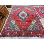 A Tabriz red ground carpet, 380 x 300cm