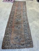 An antique Caucasian red ground runner, 372 x 106cm