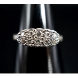 An 18ct & plat and two row diamond set cluster ring, size O, gross weight 2.7 grams.