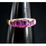 A Victorian 15ct gold and graduated five stone amethyst paste set half hoop ring, size O/P, gross