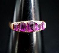 A Victorian 15ct gold and graduated five stone amethyst paste set half hoop ring, size O/P, gross
