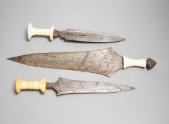 Three assorted African tribal daggers c.1900, each with ivory handle including two with decorated
