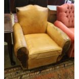 An early 20th century French tan leather armchair, width 86cm, depth 84cm, height 77cm