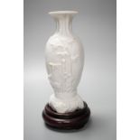 A Chinese 'deer and bamboo' moulded porcelain vase, 19th century, wood stand, height overall 20cm