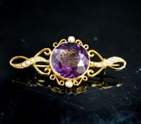 An early 20th century yellow metal, amethyst and seed pearl set brooch, 42mm, gross weight 5.2
