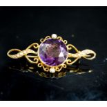 An early 20th century yellow metal, amethyst and seed pearl set brooch, 42mm, gross weight 5.2