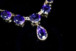 A 9ct gold and six stone oval and pear cut amethyst set drop necklace, 48 grams.7cm, gross weight