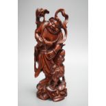 A Chinese carved cherrywood group of an immortal and a beast, early 20th century, height 24cm