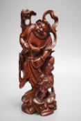 A Chinese carved cherrywood group of an immortal and a beast, early 20th century, height 24cm