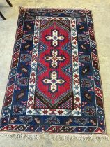 A Caucasian red ground rug, 194 x 128cm