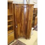 An 18th century North Italian walnut standing corner cupboard with concave door, width 130cm,