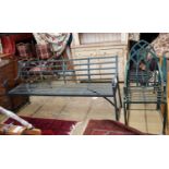 A green painted wrought iron garden bench, length 186cm, depth 46cm, height 92cm together with two