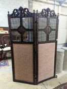A 1920's Carolean style oak and cane work two fold dressing screen, each panel width 60cm, height