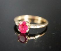 A modern 18ct gold and single stone oval cut ruby ring, with diamond set shoulders, size O, gross