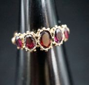 A 19th century yellow metal and graduated five stone garnet half hoop ring, size K, gross 2,.1