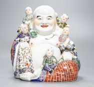 A Chinese enamelled porcelain group of Budai and boys, 19cm high