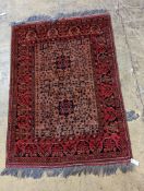 A Belouch red ground rug, 148 x 106cm