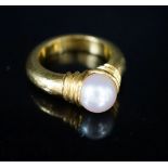 Attributed to Ilias Lalaounis, a planished 750 yellow metal set with a single cultured pearl, size