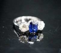 A modern 18ct white gold, single stone sapphire and two stone diamond set ring, size L, gross weight