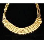 Ilias Lalaounis: a 750 yellow metal multi strand necklace, with shell motifs, 40cm, 146.3 grams,