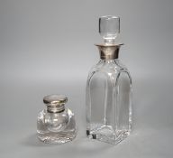 A Victorian circular heavy glass inkwell with hinged silver lid, engraved crest (London 1892) and