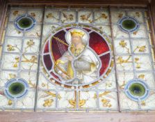 A framed Victorian stained glass panel depicting King David playing the harp, 58x70cm including