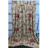 A pair of floral lined curtains. Approximate measurements: Width of top 110cm, Width of bottom 220cm