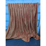 A pair of orange lined curtains. Approximate measurements: Width of top 180cm, Width of bottom 320cm