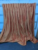 A pair of orange lined curtains. Approximate measurements: Width of top 180cm, Width of bottom 320cm