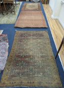Three antique rugs, Caucasian and North West Persian, largest 230 x 154cm