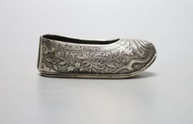 An early 20th century Chinese engraved white metal pin cushion, modelled a s a shoe, (lacking