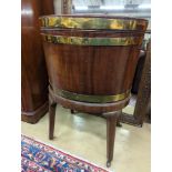 A George III mahogany triple brass bound oval wine cooler on stand, width 56cm, depth 43cm, height