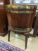 A George III mahogany triple brass bound oval wine cooler on stand, width 56cm, depth 43cm, height