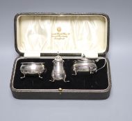 A George V cased silver three piece condiment set, London, 1931.