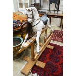 A Victorian style dapple grey rocking horse on pine stand, length 152cm, height 126cm