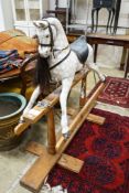 A Victorian style dapple grey rocking horse on pine stand, length 152cm, height 126cm