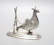 A continental novelty white metal brand balloon warmer, modelled and a game bird with crossed