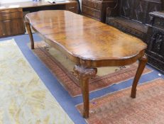 A Queen Anne revival burr walnut shaped oval extending dining table, 272cm extended, one spare leaf,
