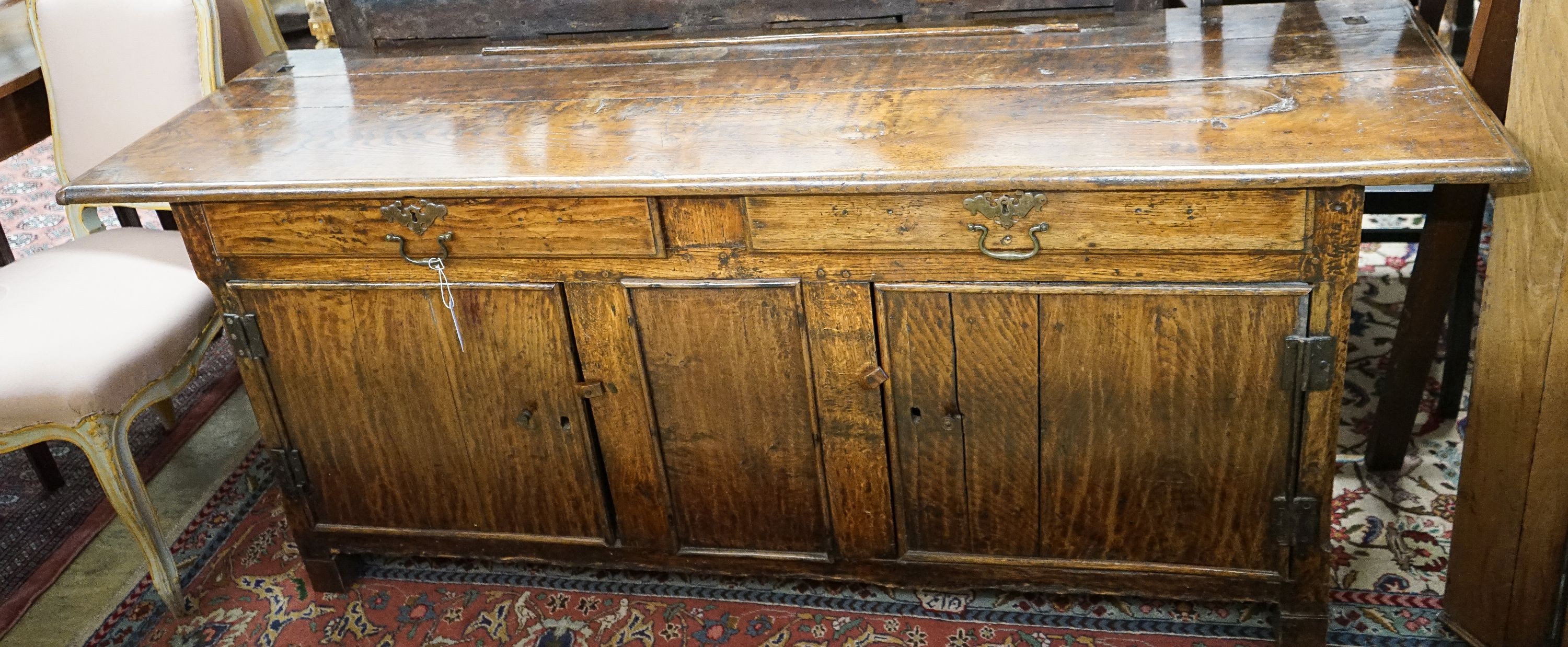 An 18th century and later oak low dresser, length 182cm, depth 52cm, height 75cm