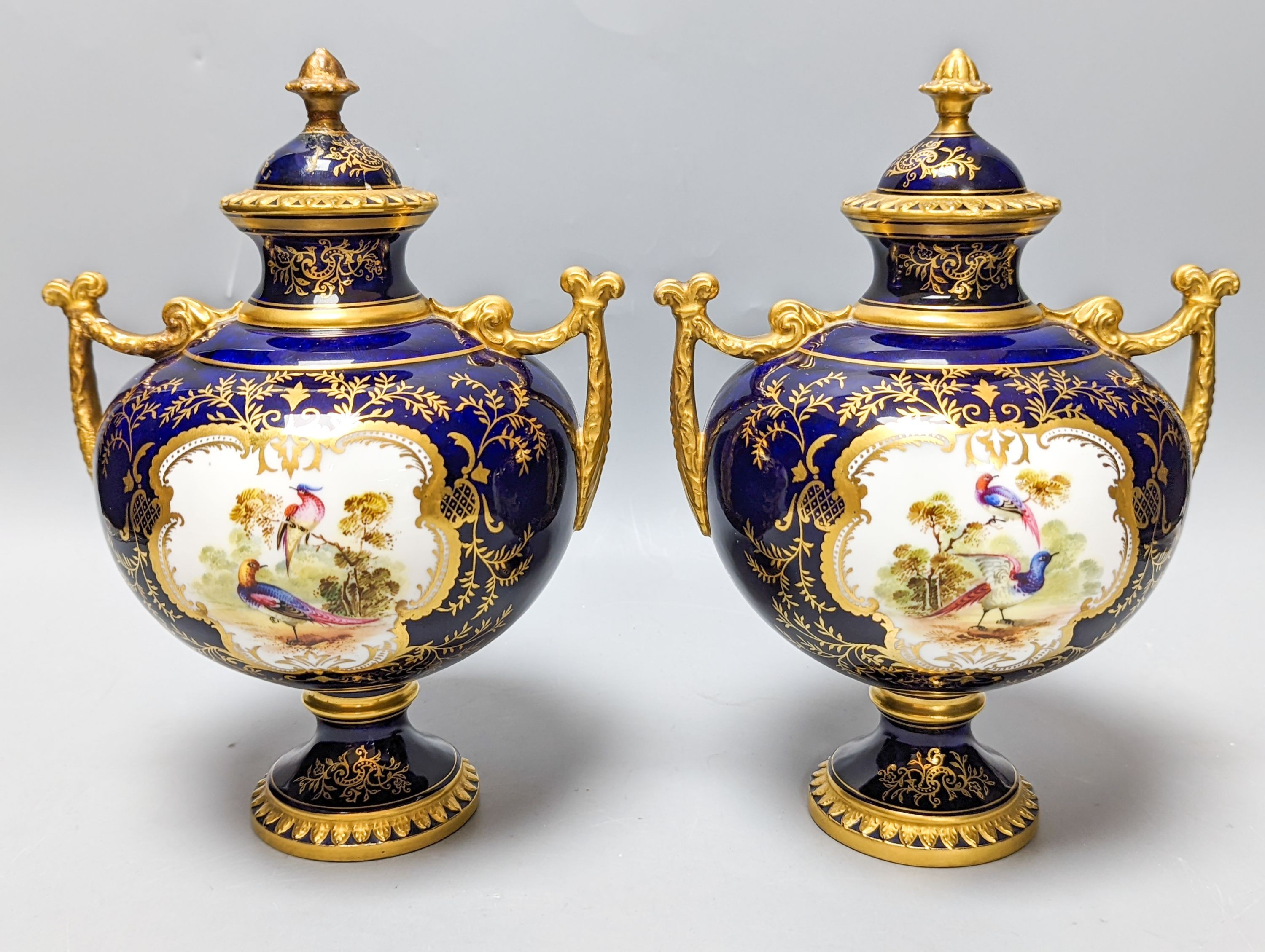 A pair of Coalport bird painted vases and covers, c.1900, inscribed Y.5146 - 22cm