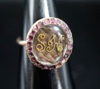 A 19th century yellow metal and gem set mounted glazed mourning ring, with 'S.H.' initialled above