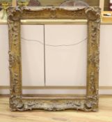 A 20th century carved giltwood scroll picture frame, aperture 78 x 63cm overall 100 x 86cm