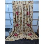 A pair of floral lined curtains. Approximate measurements: Width of top 110cm, Width of bottom 220cm