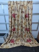 A pair of floral lined curtains. Approximate measurements: Width of top 110cm, Width of bottom 220cm