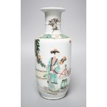 A Chinese famille verte rouleau vase, painted with figures in a garden, 22cm