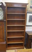 A reproduction satinwood banded yew open bookcase, length 92cm, depth 36cm, height 210cm