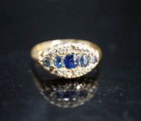 An early 20th century 18ct gold, graduated five stone sapphire and rose cut diamond set cluster