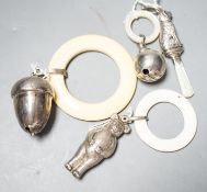 Four assorted child's silver teething rattles, including dog, bear and acorn.