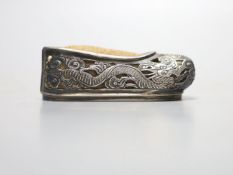 An early 20th century Chinese pierced white metal pin cushion, modelled as a shoe, maker KW, 81mm.
