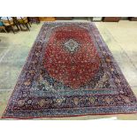 A large Tabriz red ground floral carpet, 540 x 350cm